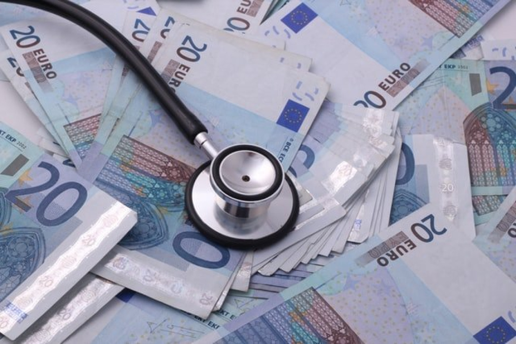 Stethoscope resting on a pile of 20 euro banknotes, symbolizing medical expenses related to workplace injuries and workers’ compensation claims in NSW.